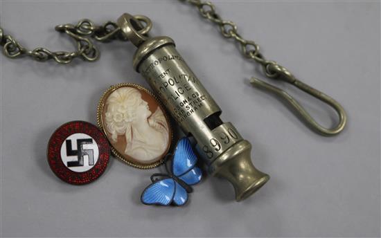 A Nazi badge, a silver enamel butterfly, a compass and a police whistle, etc